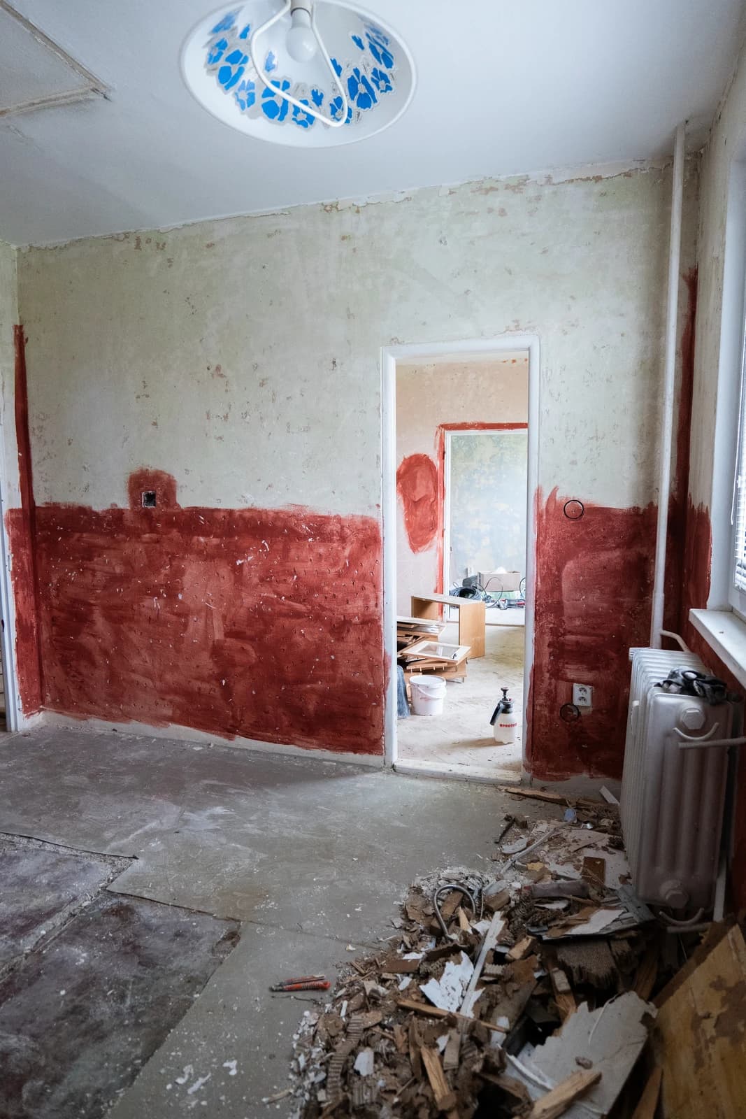 Štýlová tmavá kuchyňa s moderným osvetlením, zlatými akcentmi a elegantným jedálenským stolom.